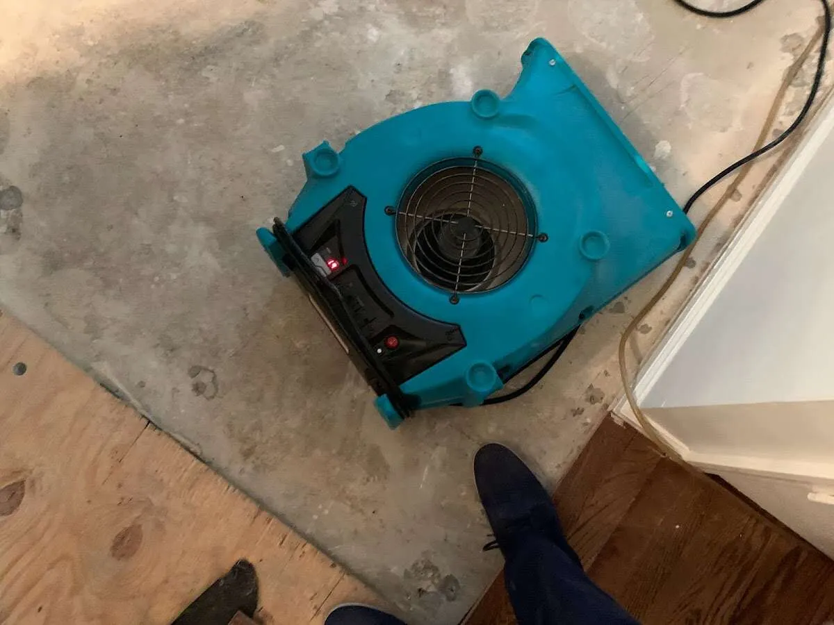 Air mover drying subfloor during Commercial Water Damage Restoration in Lafayette